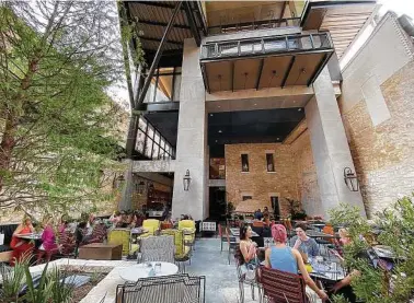  ?? Mike Sutter / Staff file photo ?? Diners linger at the Canopy by Hilton San Antonio Riverwalk. The average occupancy rate at San Antonio hotels was only slighter lower in October than it was two years ago.