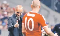  ??  ?? Bayern Munich’s coach Pep Guardiola gives a thumb up to Arjen Robben after he scored a goal against Manchester United. — Reuters photo