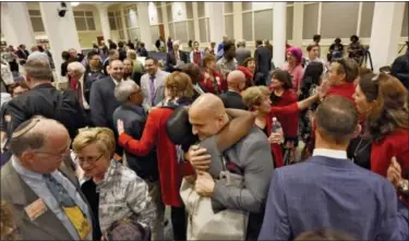  ?? BOB MACK — FLORIDA TIMES-UNION VIA AP ?? Duval Schools Superinten­dent Nikolai Vitti, center, is hugged after the Jacksonvil­le City Council voted 12-6 to support the Human Rights Ordinance (HRO) in Jacksonvil­le, Fla. At left are Rabbi Rick Shapiro, the Interim Senior Rabbi at Congregati­on...