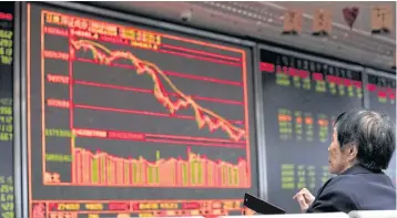  ?? REUTERS ?? An investor watches a board showing stock informatio­n at a brokerage office in Beijing, China yesterday.