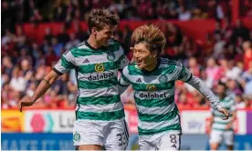  ?? Photograph: Stuart Wallace/Shuttersto­ck ?? Kyogo Furuhashi (right) celebrates with Matt O'Riley after putting Celtic 2-1 up against Aberdeen at Pittodrie.
