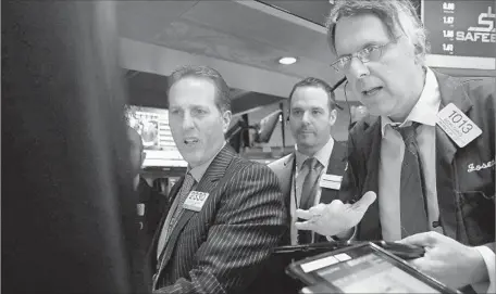  ?? Spencer Platt Getty Images ?? PRESIDENT TRUMP’S troubles in getting a healthcare bill passed weighed on stocks, particular­ly banks. Above, traders at the NYSE.