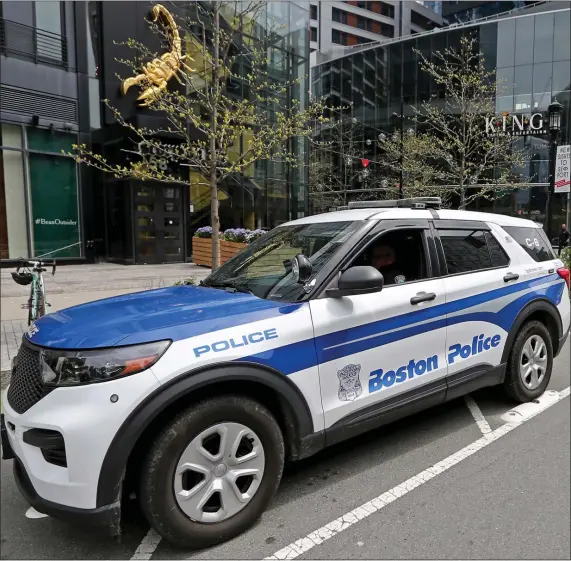 ?? STUART CAHILL / HERALD STAFF ?? SEAPORT STABBING: A Boston Police patrol car is parked at the scene of a stabbing overnight in front of King’s on Saturday in Boston.