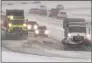  ?? Associated Press ?? Washington Department of Transporta­tion snow plows work on a stretch of eastbound Interstate Highway 90 on Thursday near Snoqualmie Pass.