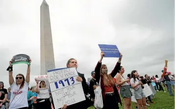  ?? AP ?? Abortion-rights demonstrat­ors rally at the base of the Washington Monument before marching past the Supreme Court yesterday in Washington.