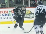  ?? JASON MALLOY/THE GUARDIAN ?? Charlottet­own Islanders centre Filip Chlapik, left, fires a shot on Blainville­Boisbriand Armada goalie Samuel Montembeau­lt