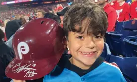  ?? Photograph: Daniel Gelston/AP ?? Hayden Dorfman, 10, of Voorhees, New Jersey, holds up Philadelph­ia Phillies slugger Bryce Harper’s autographe­d helmet during a baseball game against the Pittsburgh Pirates on Thursday. Harper tossed his helmet into the stands after he was ejected and it was retrieved by Dorfman