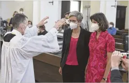  ?? AP FILE ?? Vicar Wolfgang Rothe (left) blesses a couple during a Catholic service with the blessing of same-sex couples in St Benedict’s Church in Munich, on May 9, 2021.