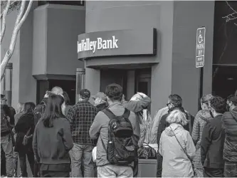  ?? David Paul Morris/bloomberg ?? Customers in line outside Silicon Valley Bank headquarte­rs in Santa Clara, California on March 13. The collapse of Silicon Valley Bank has prompted a global reckoning at venture capital and private equity firms, which found themselves suddenly exposed all together to the tech industry's money machine.