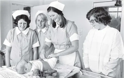  ?? PHOTO: OTAGO DAILY TIMES ?? The future of the New Zealand Karitane hospitals was clouded in 1978 but work continued unchanged at the hospital at Andersons Bay in April of that year. Darren is attended by Pam Kelly (Fairfield). With Pam are other trainee nurses, Fiona McNair...