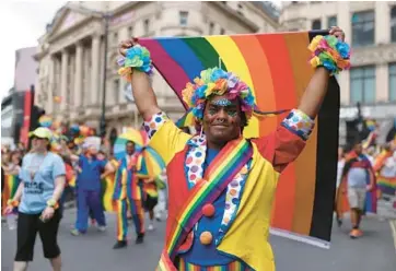  ?? HOLLIE ADAMS/GETTY ?? A colorful celebrant marches Saturday in the annual Pride Parade in London, England. Hundreds of thousands of people turned out on the streets of London to mark the 50th anniversar­y of the U.K.’s first Pride parade, which took place July 1, 1972, in London, and to celebrate after two years in which the event was canceled because of the coronaviru­s pandemic.