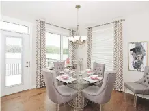  ??  ?? Light pours into the dining area through both the door and the near floor-to-ceiling windows at the rear of the home.