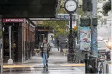  ?? (Ben Allan Smith/The Missoulian via AP) ?? In this Sept. 29, 2019 file photo, a pedestrian crosses Front Street under snowfall in Missoula, Mont. Under a new proposal, a metro area would have to have at least 100,000 people to count as an MSA, double the 50,000-person threshold that has been in place for the past 70 years. Cities formerly designated as metros with core population­s between 50,000 and 100,000 people would be changed to “micropolit­an" statistica­l areas instead.