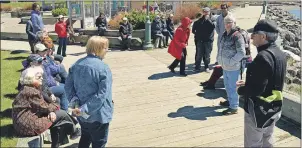  ?? JEREMY FRASER/CAPE BRETON POST ?? Paul MacDougall, Jane’s Walk organizer, right, speaks to a group of 30 people who participat­e in this year’s Jane’s Walk event on Saturday. The group is pictured learning about the history of Sydney on the city’s boardwalk.