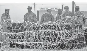  ?? JOEL MARTINEZ/THE MONITOR VIA AP ?? Troops have been fortifying barriers such as this one in southern Texas during their deployment.