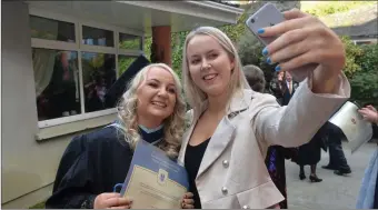  ??  ?? BA in Early Childcare Graduate Aoife O’Connor from Listowel poses for a selfie with Charlie Anne Walsh after the IT Tralee Graduation Ceremony.