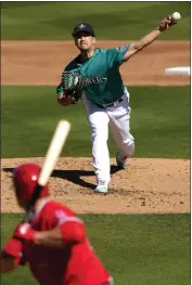  ?? CHARLIE RIEDEL – THE ASSOCIATED PRESS ?? Mariners starting pitcher Marco Gonzales throws to the Angels' Matt Thaiss during Saturday's game.