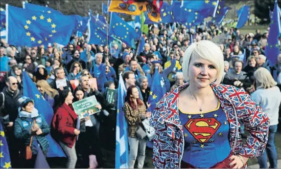  ?? RUSSELL CHEYNE / REUTERS ?? Una joven con una camiseta de Supergirl con la bandera de la UE durante una manifestac­ión en contra del Brexit, ayer en Edimburgo