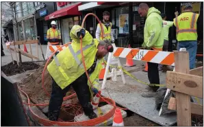  ?? (AP/Mark Lennihan) ?? Workers install conduit last month that will hold Verizon’s fiber-optic cable in New York. U.S. productivi­ty posted a sharp rebound in the January-March quarter after having fallen in the previous quarter.