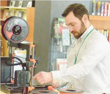  ?? JEFF VORVA/DAILY SOUTHTOWN PHOTOS ?? Evergreen Park Public Library Director Frank Murray prepares the library’s new 3D printer, Leonardo da Printi, for a demonstrat­ion during an event last week at the library.