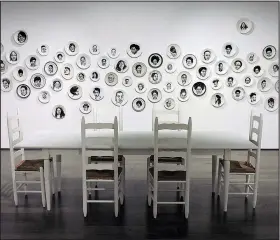  ??  ?? Delita Martin’s The Dinner Table is an installati­on with some 200 portraits on dinner plates. Seen previously at the Bradbury Art Museum at Arkansas State University, the installati­on is part of the exhibition “On Their Own Terms.”