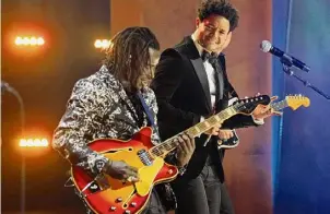  ?? Chris Pizzello/Associated Press ?? Host Trevor Noah, right, joins Eric Burton of Black Pumas onstage at the 63rd Grammy Awards at the Los Angeles Convention Center on March 11, 2021. Noah will host the 2024 Grammys on Sunday.