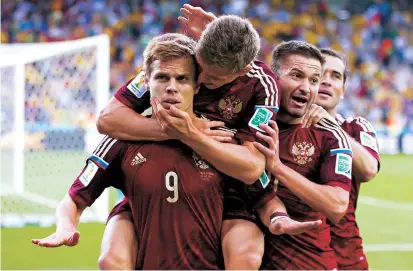  ??  ?? Alexander Kokorin celebrates (center) after scoring for Russia against Algeria at the 2014 FIFA World Cup in Brazil. Both Kokorin and Pavel Mamaev face prison for assault. — Reuters