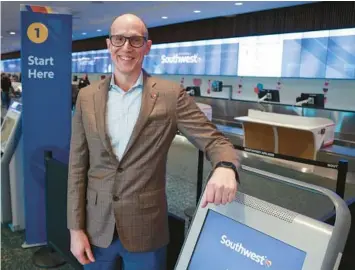  ?? RICH POPE/ORLANDO SENTINEL ?? Southwest Airlines Chief Operating Officer Andrew Watterson stands at the airline’s check-in kiosks in Terminal A at Orlando Internatio­nal Airport on Feb. 6.