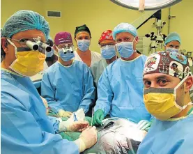  ??  ?? TEAMWORK: The doctors who performed the ground-breaking transplant