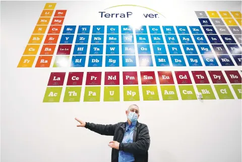  ?? Associated Press ?? TerraPower’s Michael Anderson, manager of test engineers and technician­s, talks about the large periodic table on the wall overhead during a tour last week of the nuclear reactor developmen­t facility in Everett, Wash. TerraPower plans to make its plant useful for today’s energy grid with ever more renewable power. A salt heat “battery” will allow a nuclear plant to ramp up electricit­y production on demand, offsetting dips in electricit­y when the wind isn’t blowing and sun isn’t shining.