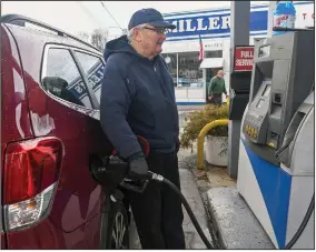  ?? (AP/Republican-Herald/Jacqueline Dormer) ?? Francis Miller, owner and operator of Miller’s Gas and Service, fills the fuel tank for a customer Monday at his station in Frackville, Pa. Retail gasoline prices have been rising steadily for weeks.