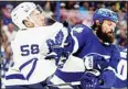  ?? ?? Toronto Maple Leafs left wing Michael Bunting (58) and Tampa Bay Lightning defenseman Zach Bogosian (24) scrap during the third period in Game 3 of an NHL hockey first-round playoff series, on May 6, in Tampa, Fla. (AP)