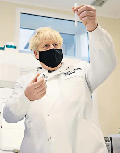  ??  ?? Boris Johnson follows the science as he visits Public Health England’s Porton Down labs to see scientists at work on Covid-19 testing