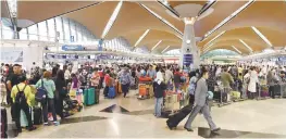  ??  ?? Passengers checking-in for their flights at KLIA.