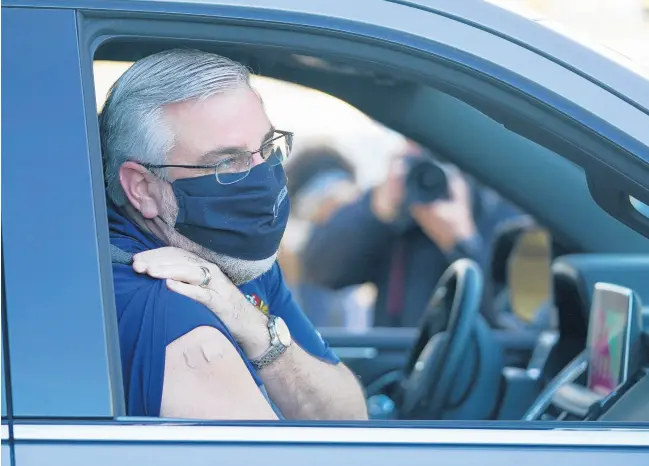  ?? DARRON CUMMINGS/AP ?? Gov. Eric Holcomb speaks after receiving his Johnson & Johnson COVID-19 vaccine March 5 during the state’s first mass vaccinatio­n clinic at the Indianapol­is Motor Speedway.