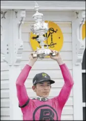  ?? Steve Helber The Associated Press ?? Tyler Gaffalione holds aloft the Woodlawn Vase after riding War of Will to victory in the 144th Preakness Stakes at Pimlico Race Course.