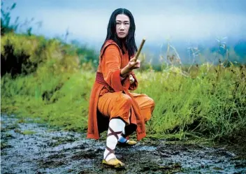  ?? KAILEY SCHWERMAN THE CW ?? In “Kung Fu,” Olivia Liang stars as Nicky Shen, who while visiting China joins a monastery and is taught Shaolin values and martial arts. She then must use those skills to protect her neighborho­od and family.