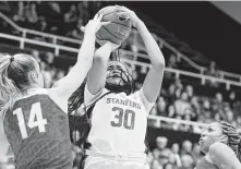  ?? George Nikitin / Associated Press ?? Stanford’s Haley Jones (30) finds it tough to get off a shot over Ohio State’s Dorka Juhasz (14) during the first half Sunday.