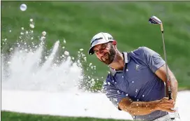  ?? CURTIS COMPTON / CCOMPTON@AJC.COM ?? Dustin Johnson blasts from the bunker to the 18th green during his practice round for the Masters at Augusta National on Tuesday.