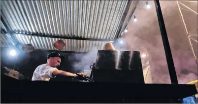  ?? AP PHOTO ?? Smoke rises above a cook preparing plates of food using a wood-burning oven at Buenos Aires’s food fair Masticar in Buenos Aires, Argentina.