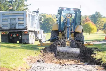  ??  ?? Rob Brown, of Berg Constructi­on, removes more dirt for a cart path Wednesday at Bethlehem Golf Club.