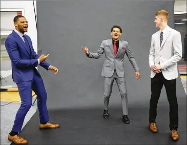  ?? JOHN BAZEMORE / ASSOCIATED PRESS ?? Newest Hawks Omari Spellman, Trae Young (middle) and Kevin Huerter, all acquired in the first round of last month’s NBA draft, have some fun after a photo shoot in Atlanta.