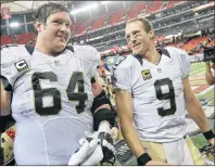  ?? AP PHOTO ?? In this Jan. 3, 2016, file photo, New Orleans Saints quarterbac­k Drew Brees walks off the field with tackle Zach Strief after an NFL game against the Atlanta Falcons in Atlanta. Strief retired on Monday.