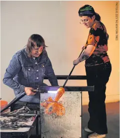  ?? ?? Deborah Czeresko, left, and her assistant work on a piece at Urban Glass in Brooklyn, on April 17.