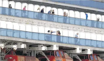  ?? NOAH BERGER/AP ?? Passengers look out from balconies Sunday on the Grand Princess off the coast of San Francisco.