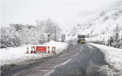  ??  ?? > A snowplough clears the closed A470 from Merthyr Tydfil to Brecon