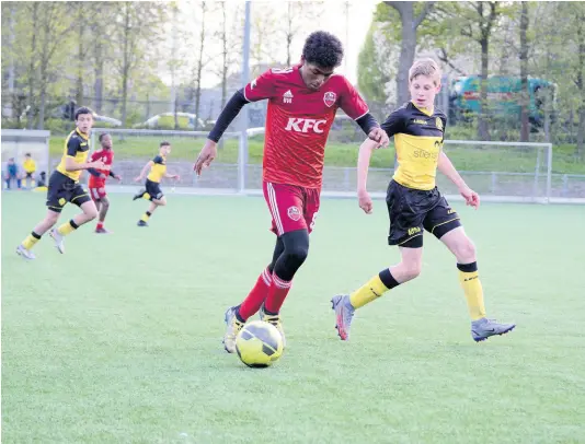  ?? CONTRIBUTE­D ?? Kingston Football Academy Striker and top scorer Kai Myles dribbles during a game between the academy’s U14 team and Roda JC recently.