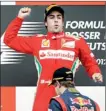  ??  ?? Fernando Alonso celebrates his victory as second placed Sebastian Vettel walks to the podium during the German F1 Grand Prix at the Hockenheim­ring in Hockenheim -REUTERS