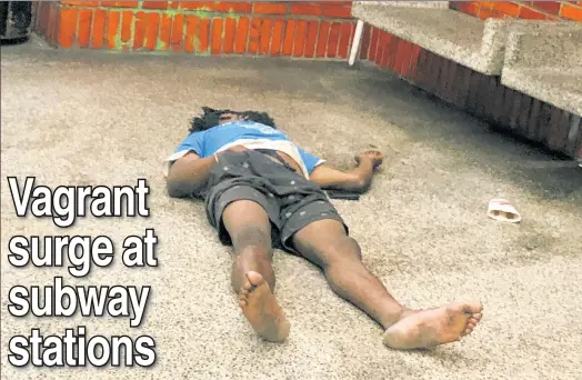  ??  ?? DOWN & OUT: A man sprawls out in the 49th Street station. An MTA tally has found a 45 percent rise in homelessne­ss at eight vagrancy-plagued stations.