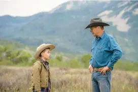  ?? CAM MCLEOD/PARAMOUNT NETWORK ?? Brecken Merrill, left, and Kevin Costner in “Yellowston­e.”